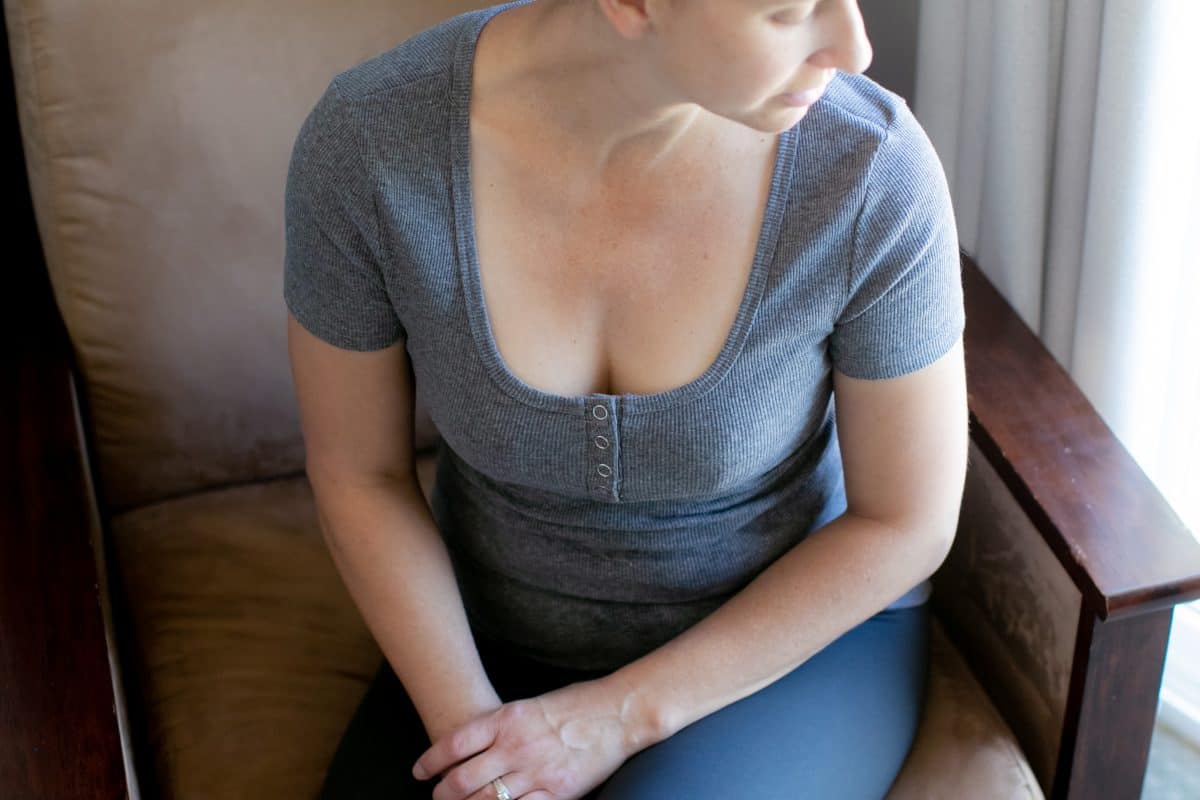 A woman looking outside wearing a push up bra inside